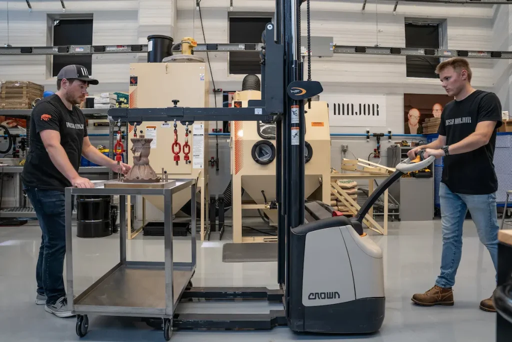 Ursa Major team members Thomas Pomorski and Ty Barzak handle 3D-printed rocket engine components at the company’s Youngstown, Ohio advanced manufacturing facility. The advanced copper alloy-based rocket engine parts will be used in space launch and hypersonics.